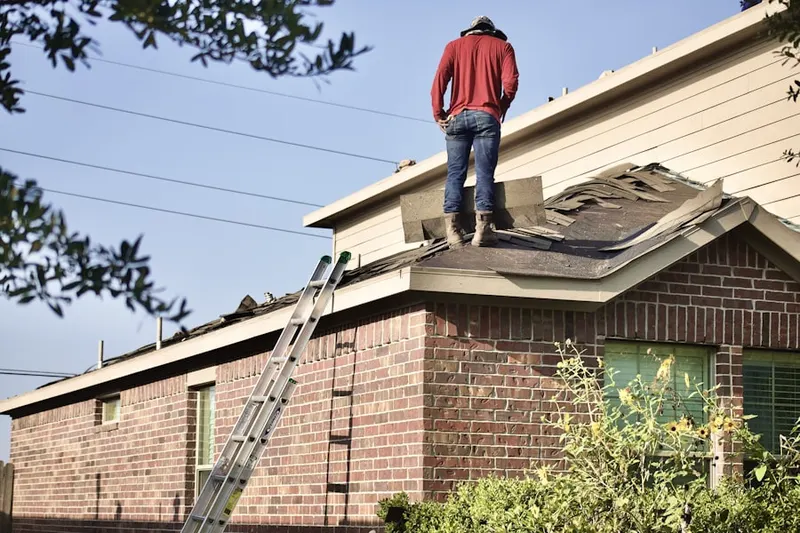Professional roofer working on a residential roof in Chisolms